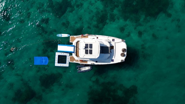 SHASH luxury power catamaran with water slide anchored at a Phuket island on a boat charter